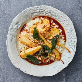 Risotto met ovengeroosterde pastinaak, maiskip en salie Risotto met ovengeroosterde pastinaak, maiskip en salie